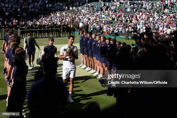 Mens Singles Final - Novak Djokovic v Kevin Anderson - A general view of Centre Court as Novak Djokovic walks down a tunnel of ball boys with the...