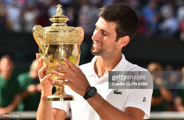 Serbia's Novak Djokovic poses with the winners trophy after beating South Africa's Kevin Anderson 6-2, 6-2, 7-6 in their men's singles final match on...