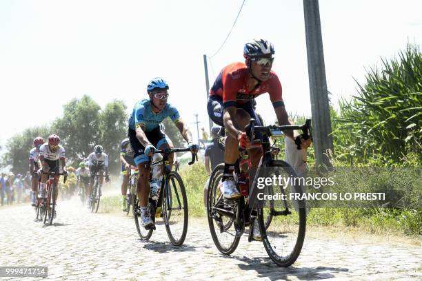 Riders pedal through the stage's fifth cobblestone section between Tilloy and Sars-et-Rosieres during the ninth stage of the 105th edition of the...