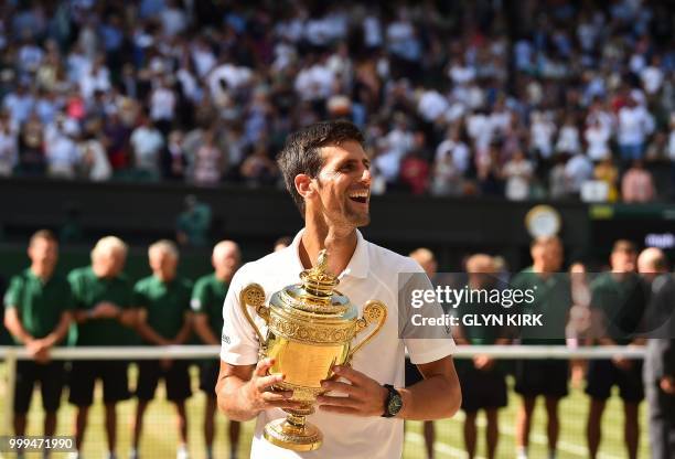 Serbia's Novak Djokovic poses with the winners trophy after beating South Africa's Kevin Anderson 6-2, 6-2, 7-6 in their men's singles final match on...