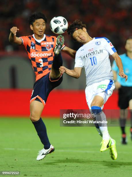 Hiroyuki Komoto of Omiya Ardija and Noriaki Fujimoto of Oita Trinita compete for the ball during the J.League J2 match between Omiya Ardija and Oita...