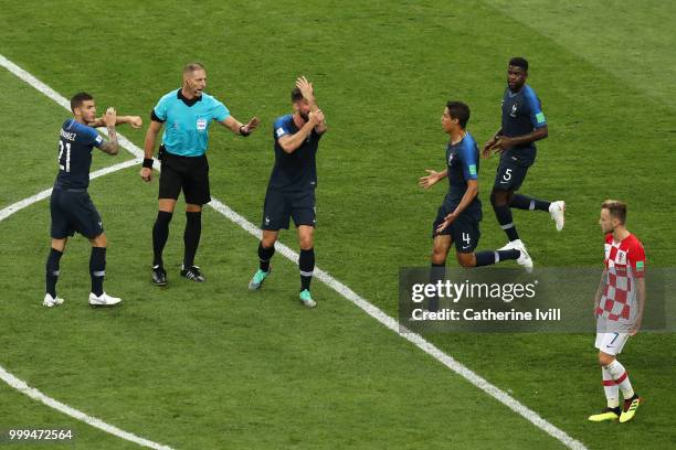 Lucas Hernandez of France and Olivier Giroud of France call for a handball before referee Nestor Pitana consults VAR and consequently awards France a...