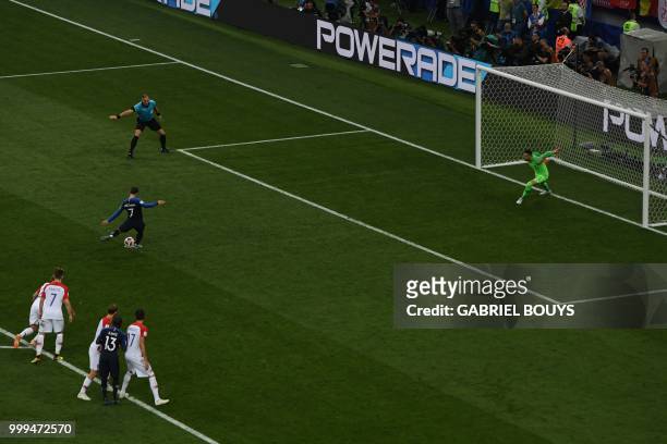France's forward Antoine Griezmann scores a penalty kick during the Russia 2018 World Cup final football match between France and Croatia at the...