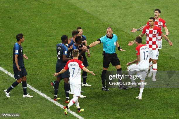 France players confront referee Nestor Pitana after they think they should be awarded a penalty for a handball by Ivan Perisic of Croatia inside the...