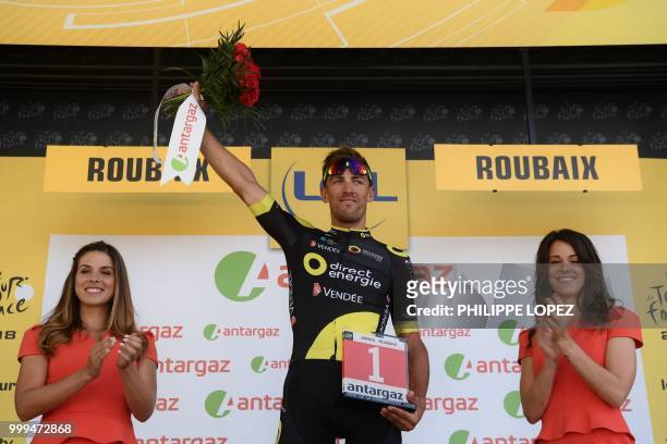 France's Damien Gaudin celebrates on the podium after being named the stage's most aggressive rider after the ninth stage of the 105th edition of the...