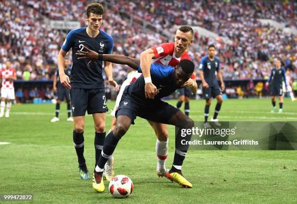 Paul Pogba of France is challened by Ivan Perisic of Croatia during the 2018 FIFA World Cup Final between France and Croatia at Luzhniki Stadium on...