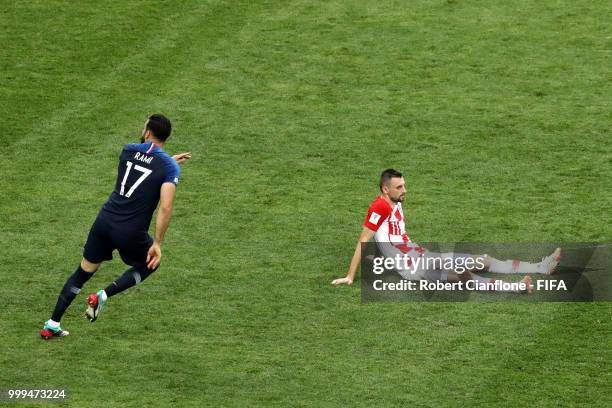 Adil Rami of France celebrates following his sides victory as Marcelo Brozovic of Croatia looks dejected following his sides defeat in the 2018 FIFA...