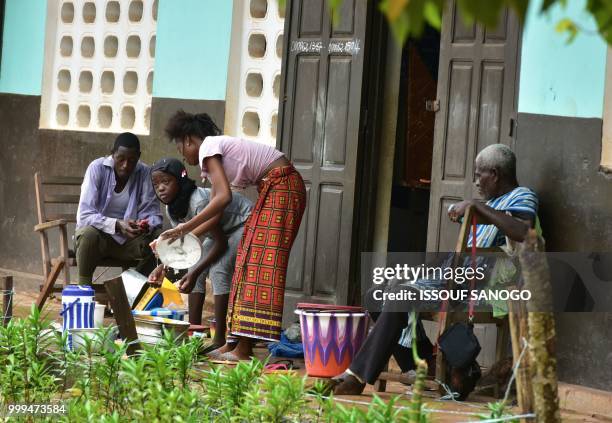 This picture taken on July 14, 2018 shows people who found shelter at a school after their neighbourhood was flooded duribg heavy rainfall in...