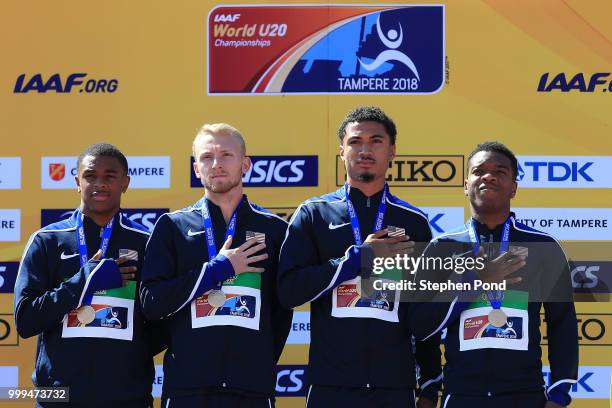 Eric Harrison, Anthony Schwartz, Austin Kratz and Micah Williams of The USA celebrate with their medals during the medal ceremony for the men's...