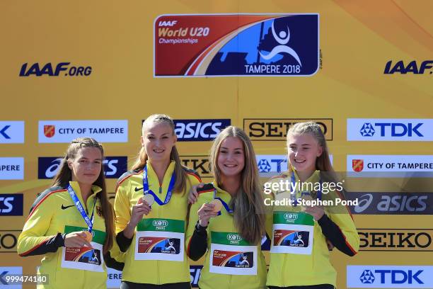 Denise Uphoff, Sophia Junk, Victoria Donicke and Corinna Schwab of Germany celebrate with their medals during the medal ceremony for the women's...