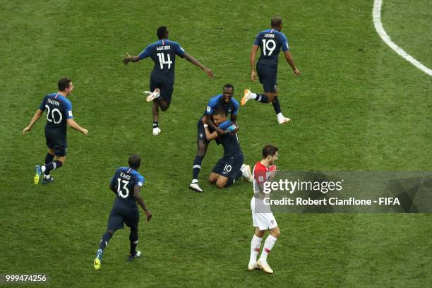 Sime Vrsaljko of Croatia looks dejeceted as France players celebrate following their sides victory in the 2018 FIFA World Cup Final between France...