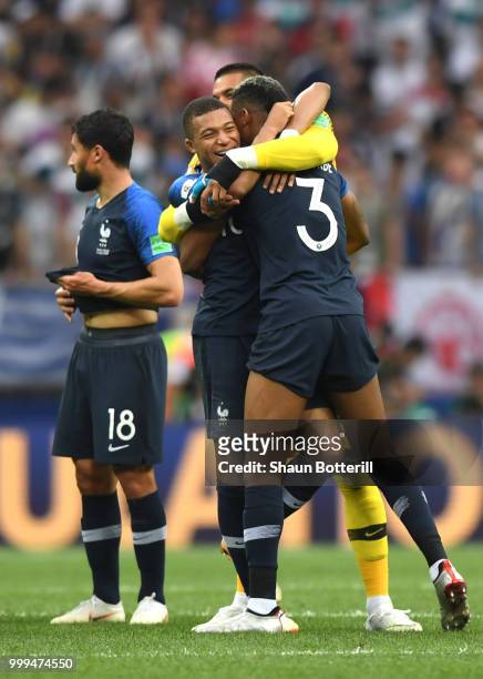 Kylian Mbappe, Alphonse Areola and Presnel Kimpembe of France celebrate victory following the 2018 FIFA World Cup Final between France and Croatia at...