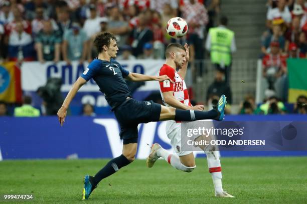 France's defender Benjamin Pavard and Croatia's forward Ante Rebic vie for the ball during the Russia 2018 World Cup final football match between...