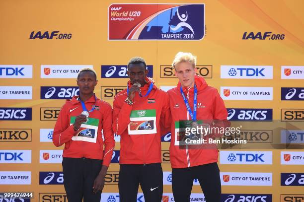 Ngeno Kipngetich of Kenya, Solomon Leukta of Kenya and Eliot Crestan of Belgium celebrate with their medals during the medal ceremony for the men's...