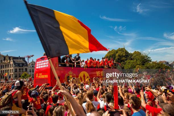 Supporters cheer as an open bus with the Red Devils pass by on their way to the Grand Place, Grote Markt in the city centre of Brussels, as Belgian...