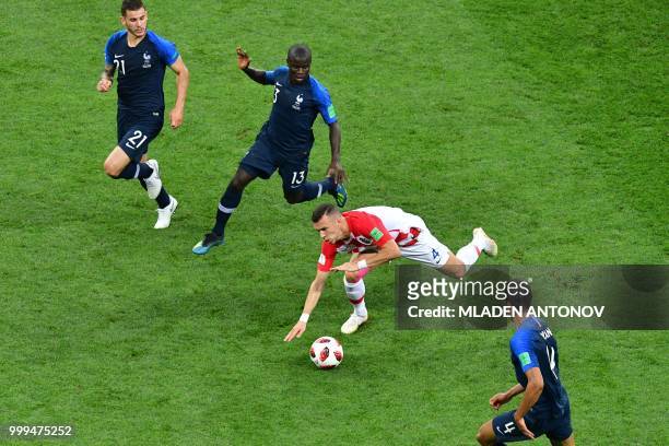 France's defender Lucas Hernandez, France's midfielder N'Golo Kante and France's defender Raphael Varane vie for the ball with Croatia's forward Ivan...