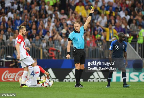 Referee Nestor Pitana books Ngolo Kante of France for a foul on Ivan Perisic of Croatia during the 2018 FIFA World Cup Final between France and...