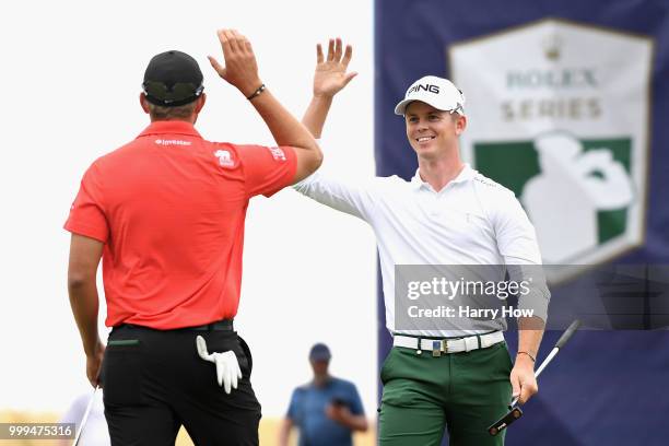 Brandon Stone of South Africa is congratulated for his eagle putt on hole sixteen by Dean Burmester of South Africa during day four of the Aberdeen...