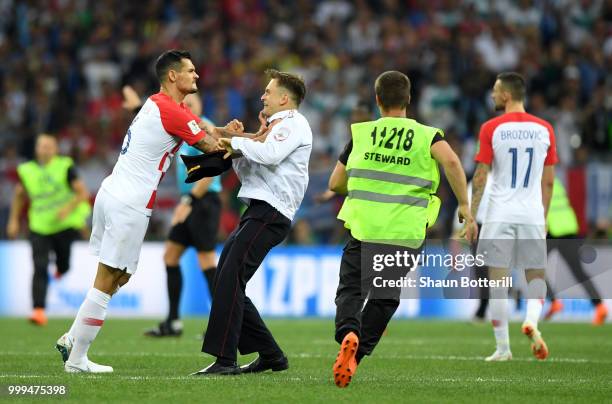 Dejan Lovren of Croatia confronts a pitch invader during the 2018 FIFA World Cup Final between France and Croatia at Luzhniki Stadium on July 15,...