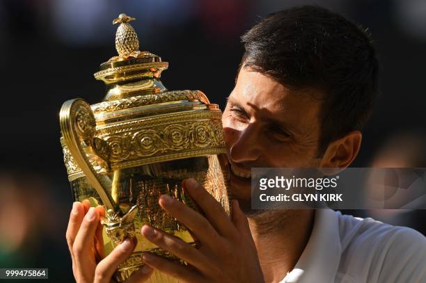 Serbia's Novak Djokovic kisses the winners trophy after beating South Africa's Kevin Anderson 6-2, 6-2, 7-6 in their men's singles final match on the...