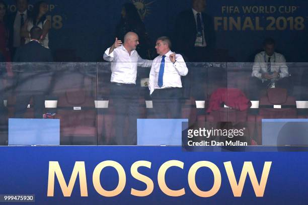 President Gianni Infantino talks with International Olympic Committee president Thomas Bach as they attend the 2018 FIFA World Cup Final between...