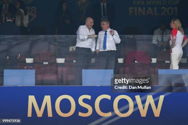 President Gianni Infantino talks with International Olympic Committee president Thomas Bach as they attend the 2018 FIFA World Cup Final between...
