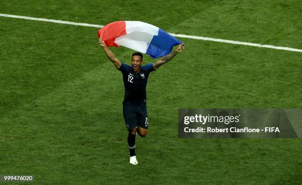 Corentin Tolisso of France celebrates his side's victory, displaying the French flag, following the 2018 FIFA World Cup Final between France and...