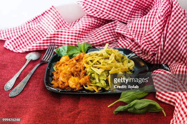 spaghetti with pesto sauce and shrimp on a the table - pesto stock pictures, royalty-free photos & images