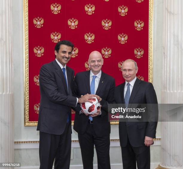 Emir of Qatar Sheikh Tamim bin Hamad Al Thani , FIFA President Gianni Infantino and Russian President Vladimir Putin attend the handover ceremony for...