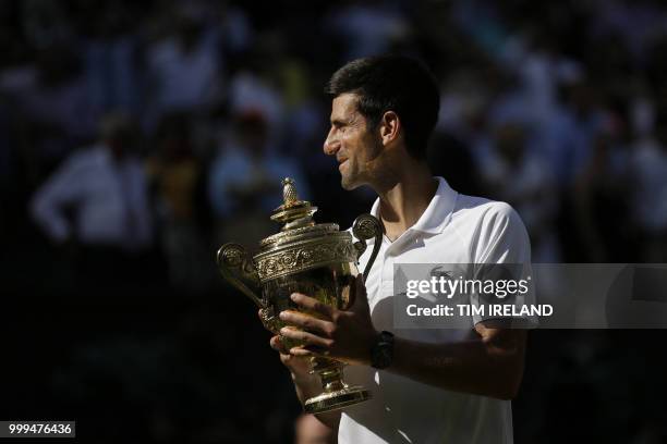 Serbia's Novak Djokovic holds the winners trophy after beating South Africa's Kevin Anderson 6-2, 6-2, 7-6 in their men's singles final match on the...
