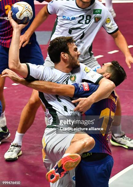 Barcelona's Viran Morros de Argila tries to prevent the shot of Berlin's Petar Nenadic during the handball final match between Fueche Berlin and FC...