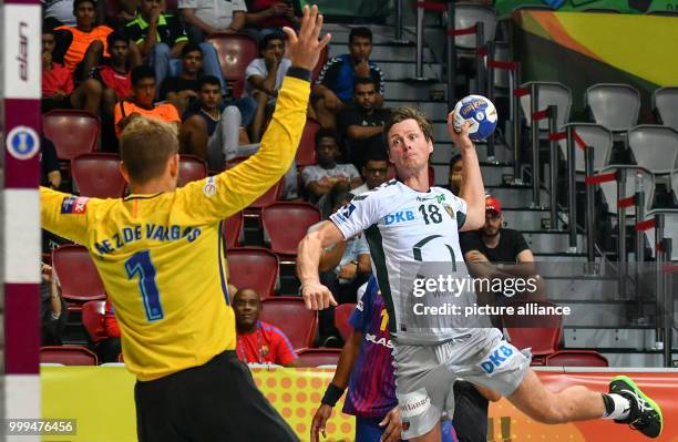 Barcelona's goalkeeper tries to save the shot on goal by Berlin's Hans Lindberg during the handball final match between Fueche Berlin and FC...