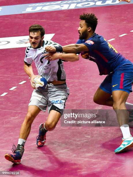 Berlin's Petar Nenadic tries to get past Barcelona's Timothey N'Guessan during the handball final match between Fueche Berlin and FC Barcelona at the...