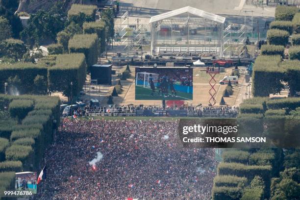 This picture taken from the panoramic observatory of the Montparnasse Tower shows a view of the fan zone where people watch the Russia 2018 World Cup...