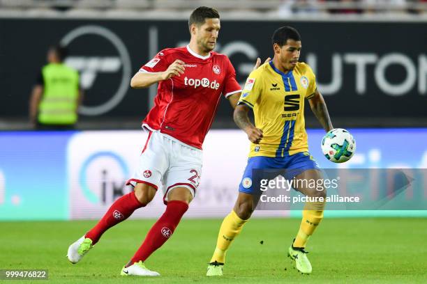 Kaiserslautern's Stipe Vucur and Braunschweig's Onel Hernandez vie for the ball during the German Second Bundesliga soccer match between 1. FC...