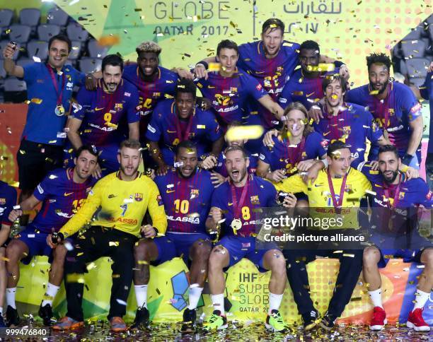 Dpatop - The players of the FC Bacelona with team captain Victor Tomas celebrate their victory after the ending of the handball final match between...