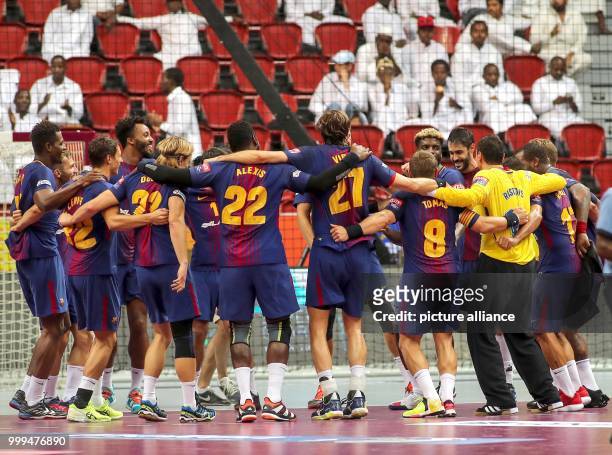 The players of the FC Bacelona celebrate their victory after the ending of the handball final match between Fueche Berlin and FC Barcelona at the IHF...