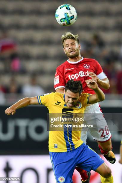 Kaiserslautern's Daniel Halfar heads the ball above Braunschweig's Mirko Boland during the German Second Bundesliga soccer match between 1. FC...