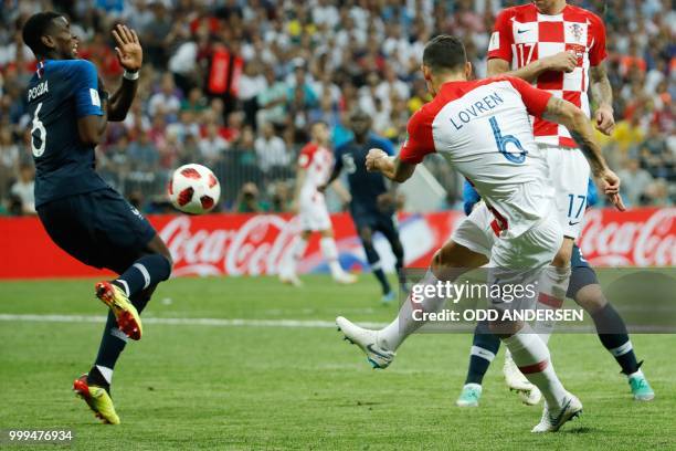 Croatia's defender Dejan Lovren shoots the ball towards France's midfielder Paul Pogba during the Russia 2018 World Cup final football match between...