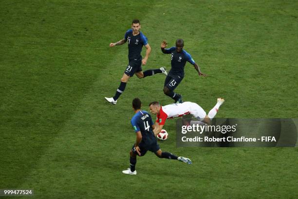 Lucas Hernandez, Ngolo Kante and Raphael Varane of France put pressure on Ivan Perisic of Croatia as he goes down during the 2018 FIFA World Cup...