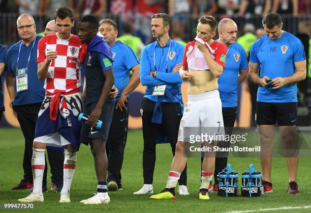 Ivan Rakitic of Croatia shows his dejection while team mate Mario Mandzukic of Croatia talks to Blaise Matuidi of France during the 2018 FIFA World...