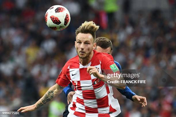 Croatia's midfielder Ivan Rakitic vies with France's forward Antoine Griezmann during the Russia 2018 World Cup final football match between France...