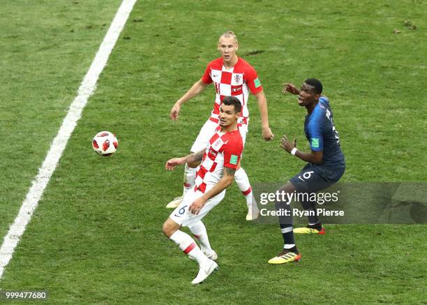 Paul Pogba of France challenge for the ball with Dejan Lovren and Domagoj Vida of Croatia during the 2018 FIFA World Cup Final between France and...