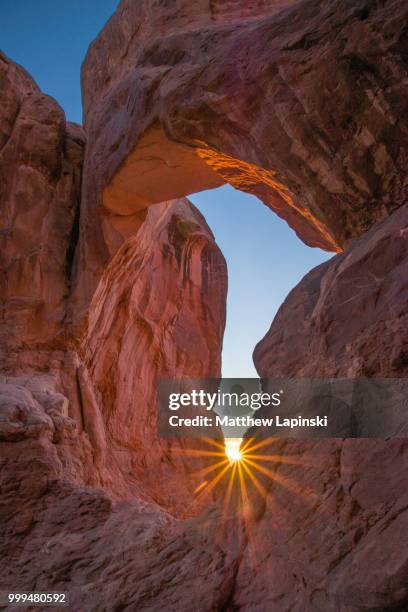 double arch sunburst - double arch stock pictures, royalty-free photos & images