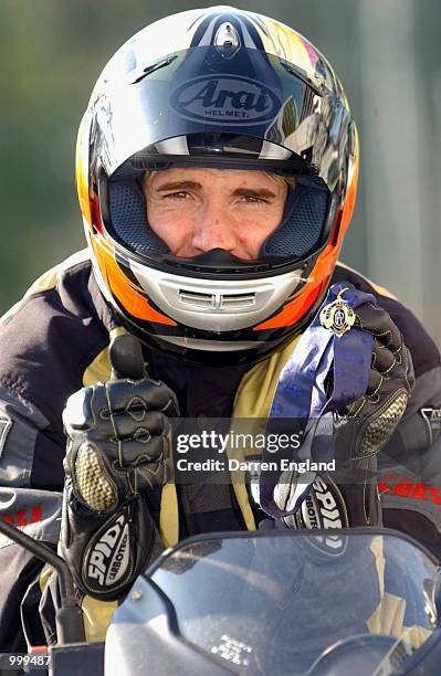 Jason Akermanis of the Brisbane Lions poses for a photo with the AFL Brownlow Medal as he leaves training on his motorbike at the Gabba in Brisbane,...