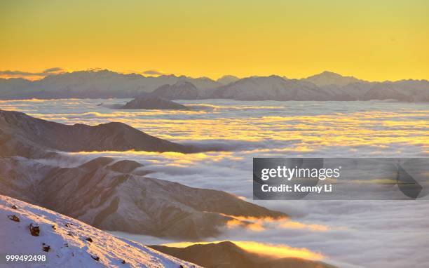 sunlight shines through clouds into mountains - kenni stock pictures, royalty-free photos & images