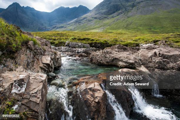 the fairy pools in glen brittle with cuillin hills behind, isle of skye, scotland, united kingdom - cuillins stockfoto's en -beelden