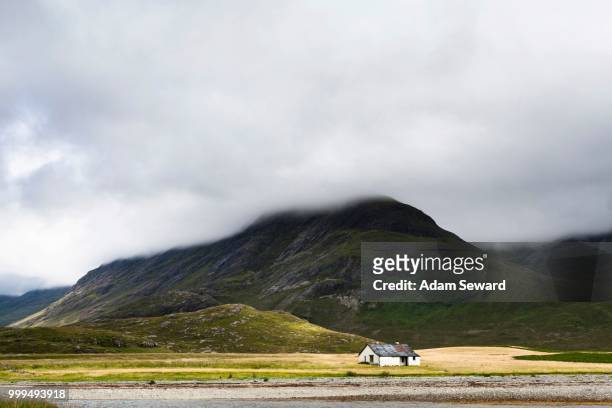 bothy at camasunary with bla bheinn mountain behind, isle of skye, scotland, united kingdom - highland islands stock pictures, royalty-free photos & images