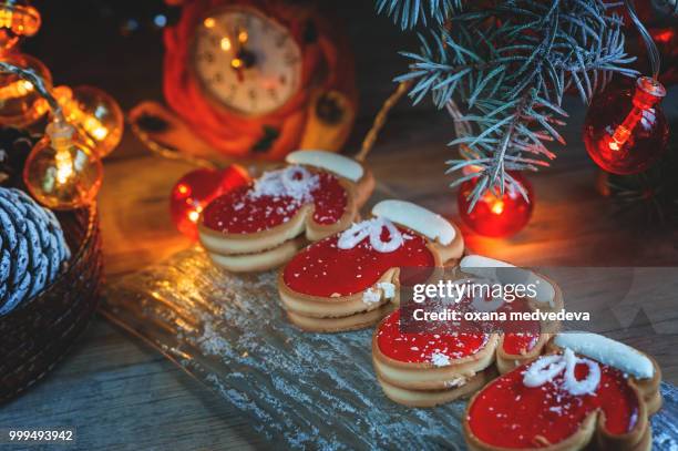 two of the pie dough mittens and marmalade with black coffee on a cozy christmas table. close-up.... - medvedeva ストックフォトと画像