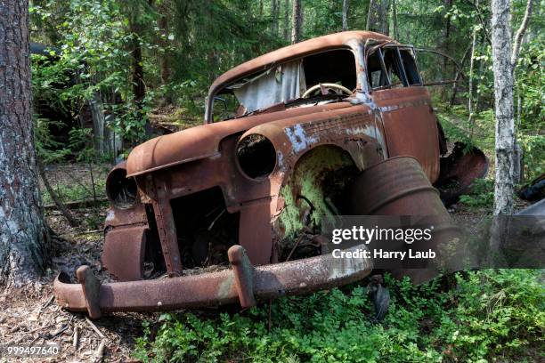 junkyard in the forest, junk car, 40s, at ryd, smaland, sweden - junk ストックフォトと画像